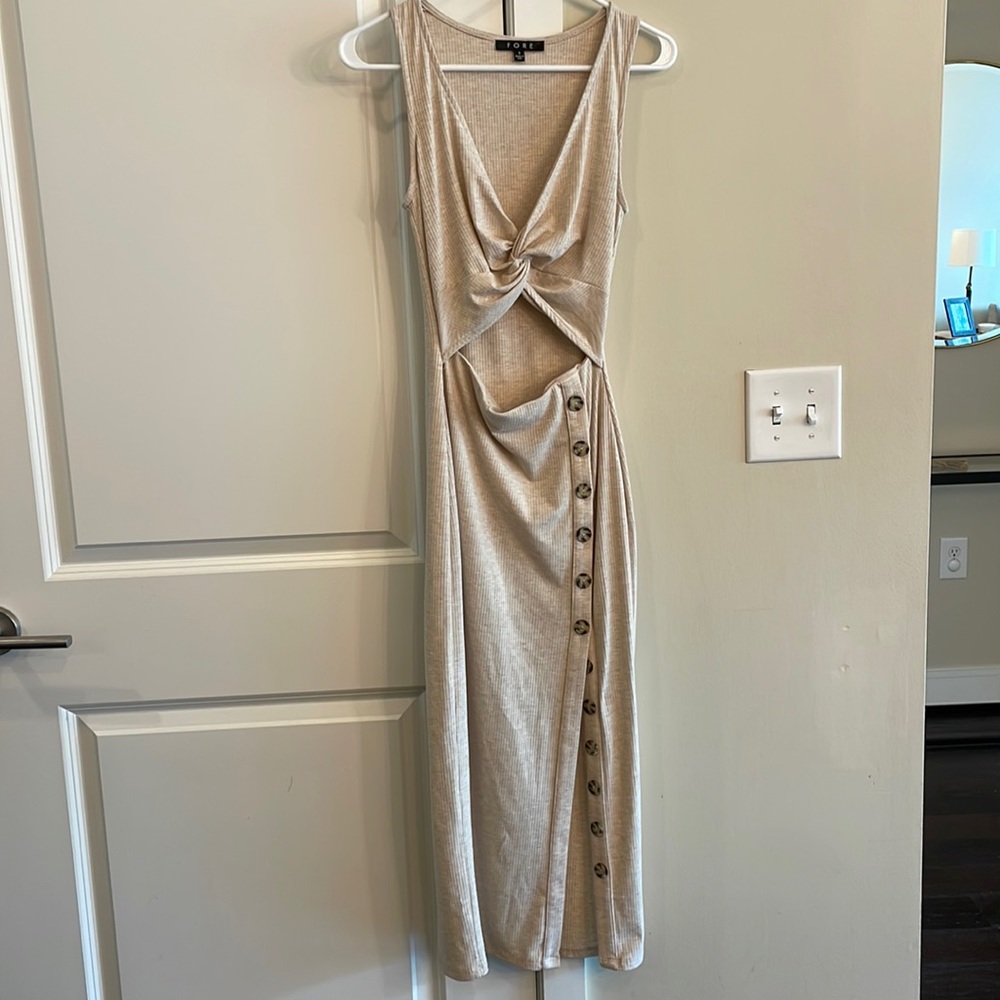 Fore beige dress with twist top, open midriff, and button detail